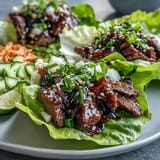 Juicy Korean BBQ Beef Lettuce Wraps with vibrant kimchi, ready to be enjoyed!