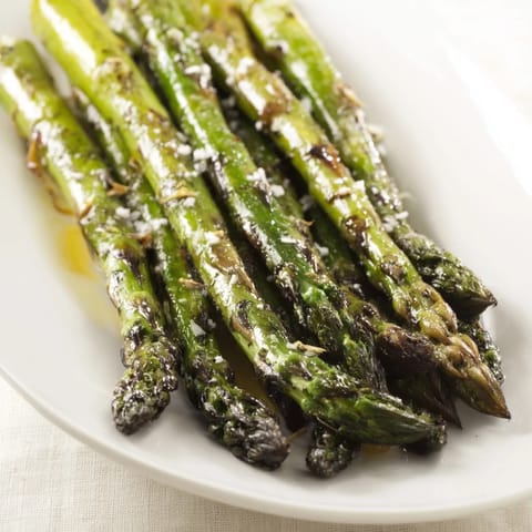 Tender charred Grilled Asparagus served warm as an easy vegan side dish for dinner.