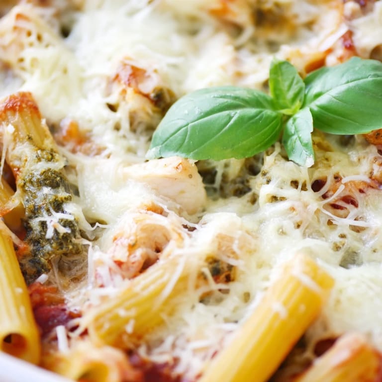 This Pesto Chicken Pasta Bake features golden, bubbling mozzarella atop penne and chicken.