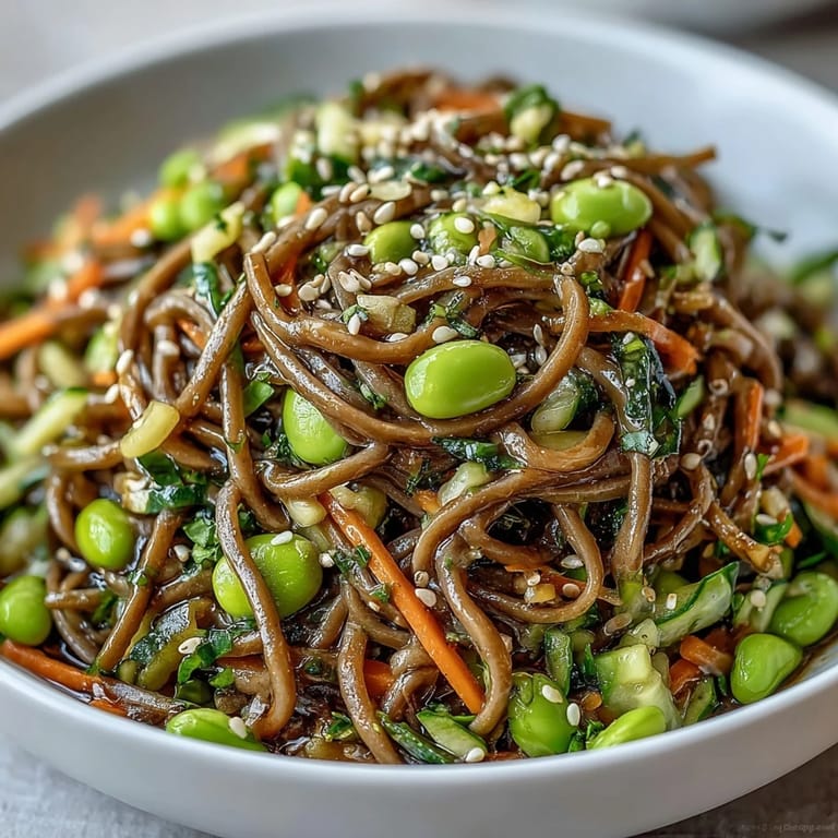 Served Soba Noodle Bowl in a ceramic dish, highlighting a light lunch option with julienned carrots, cucumber, and fresh herbs.